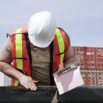 Man inspecting pipe